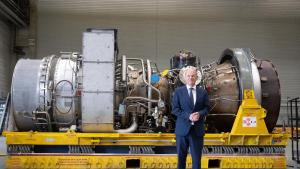 dpatopbilder - Bundeskanzler Olaf Scholz vor der in Kanada für die Erdgas-Pipeline Nordstream 1 gewarteten Turbine. Foto: Bernd Thissen/dpa
