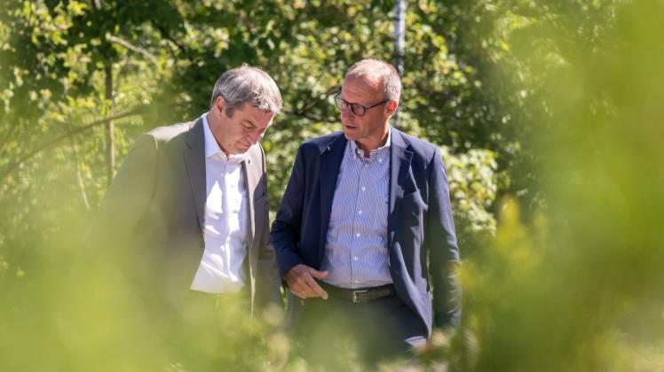 Markus Söder, (l, CSU) Ministerpräsident von Bayern, und CDU-Bundesvorsitzende Friedrich Merz unterhalten sich bei ihrem Besuch des Kernkraftwerk Isar 2. Foto: Peter Kneffel/dpa