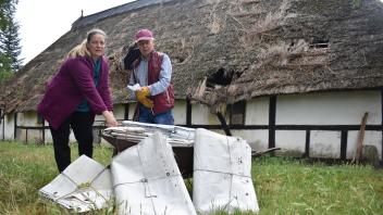 Die Segel-Planen, die Dietmer Graf aus Kiel gebracht hat, helfen Ines Beckmann, das Reetdach des alten Hallenhauses auf dem Hof ihrer Familie in Lichtenhagen Dorf not zu sichern.