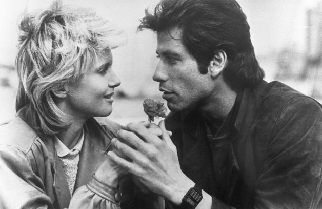 (FILES) In this file photo taken 1983 US actor John Travolta and British-Australian actress and singer Olivia Newton-John shoot the film "Two of a kind" directed by John Herzteld and released in 1983. - Australian singer Olivia Newton-John, who gained worldwide fame as high-school sweetheart Sandy in the hit musical movie "Grease," died on August 8, 2022, her family said. She was 73. The entertainer, whose career spanned more than five decades, devoted much of her time and celebrity to charities after being diagnosed with breast cancer in 1992. (Photo by AFP)