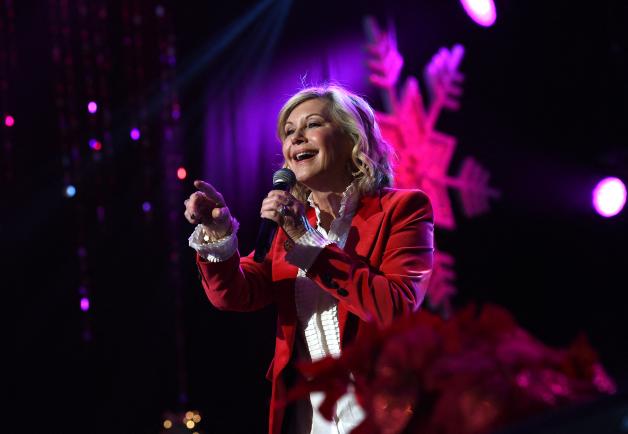 (FILES) In this file photo taken on November 27, 2016 Olivia Newton John performs at the 85th annual Hollywood Christmas parade on Hollywood Boulevard in Hollywood. - Australian singer Olivia Newton-John, who gained worldwide fame as high-school sweetheart Sandy in the hit musical movie "Grease," died on August 8, 2022, her family said. She was 73. The entertainer, whose career spanned more than five decades, devoted much of her time and celebrity to charities after being diagnosed with breast cancer in 1992. (Photo by CHRIS DELMAS / AFP)