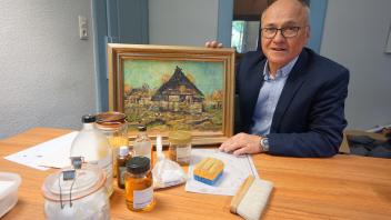Museumsleiter Oliver Fok zeigt unterschiedliche Möglichkeiten, ein Bild zu restaurieren. 