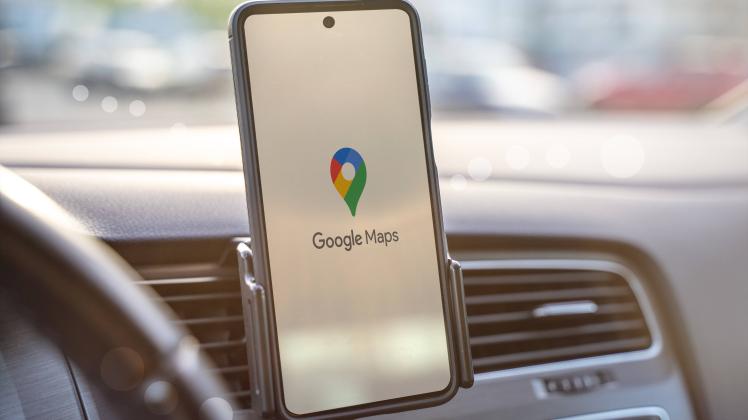Augsburg, Bavaria, Germany - May 24, 2021: Google Maps navigation on smartphone while driving a car.