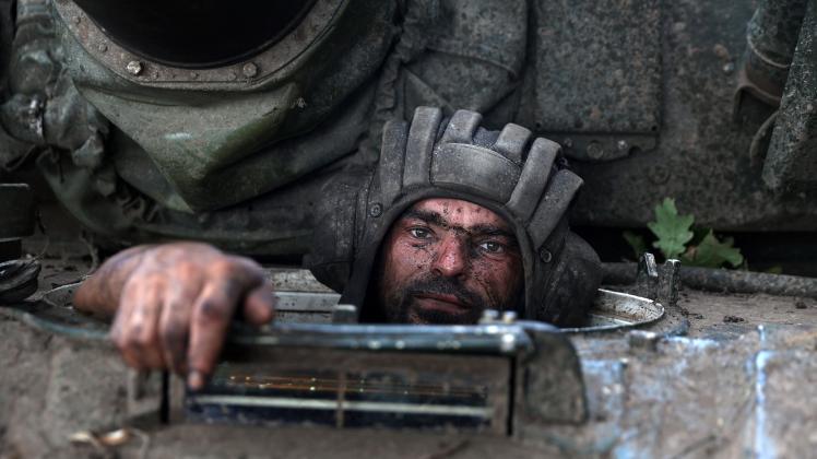 A Ukrainian tank driver sits in his tank at the front line in the Donetsk region on August 19, 2022, amid Russia's invasion of Ukraine. (Photo by ANATOLII STEPANOV / AFP)