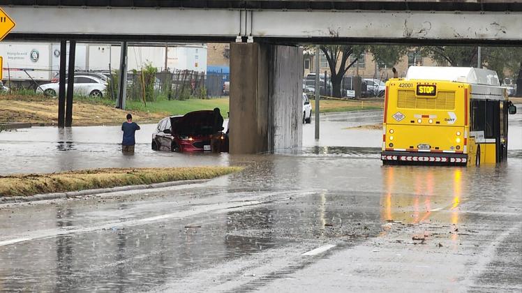 August 22, 2022, Dallas, Texas, USA: In a handout photo from the , a car and bus sit in flood waters after heavy rain ca