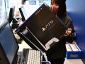 (FILES) This file photo taken on November 12, 2020 shows an employee handling a newly-purchased Sony PlayStation 5 gaming console for a customer on the first day of its launch, at an electronics shop in Kawasaki, Kanagawa prefecture. - The consoles made by Sony and Microsoft have been hard to buy since their November 2020 release, as has Nintendo&apos;s Switch, with supply chain issues exacerbated by lockdowns in China. (Photo by CHARLY TRIBALLEAU / AFP) / TO GO WITH AFP STORY JAPAN-GAMES-COMPUTERS-SEMICONDUCTORS,FOCUS BY MATHIAS CENA
