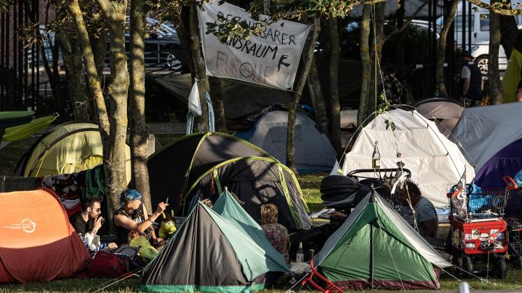 Punker-Camp in Westerland 04.08.2022, Westerland --- Punker sitzen neben Zelten vom Protest-Camp neben dem Rathaus auf