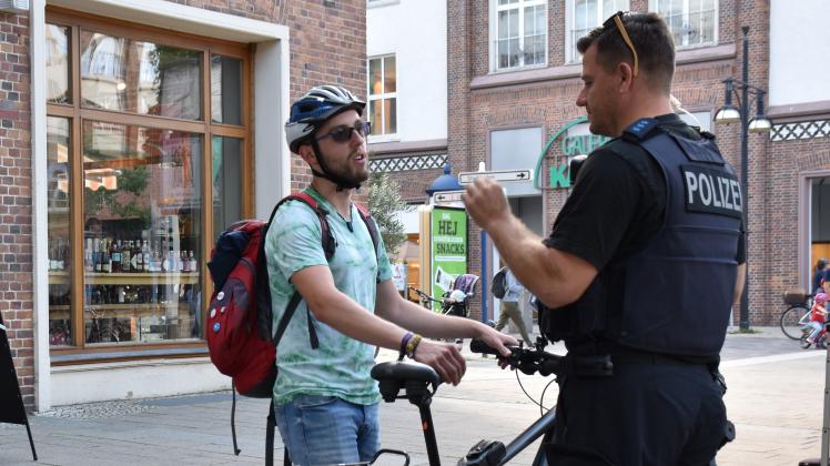 In der Langen Straße in Rostock führte die Polizei am Donnerstag Kontrollen zur Fahrradstraße durch. Auch Niklas Plage (l.) wurde angehalten, weil er statt auf der Straße auf dem Gehweg fuhr.