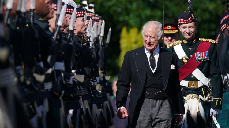 Britain&apos;s King Charles III inspects an Honour Guard as he arrives at the Palace of Holyroodhouse, in Edinburgh, on September 12, 2022. - Mourners will on September 12, 2022 get the first opportunity to pay respects before the coffin of Queen Elizabeth II, as it lies in an Edinburgh cathedral where King Charles III will preside over a vigil. (Photo by Peter Byrne / POOL / AFP)