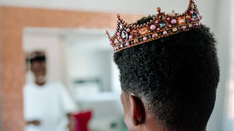 Creative Highlights Symbolfotos African-American boy wearing jeweled crown looking in mirror San Diego, CA, United State