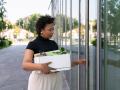 Businesswoman holding box opening glass door model released, Symbolfoto, VPIF06938