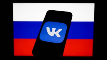 Russia And Technology Companies Photo Illustrations V Kontakte logo displayed on a phone screen and Russian flag display