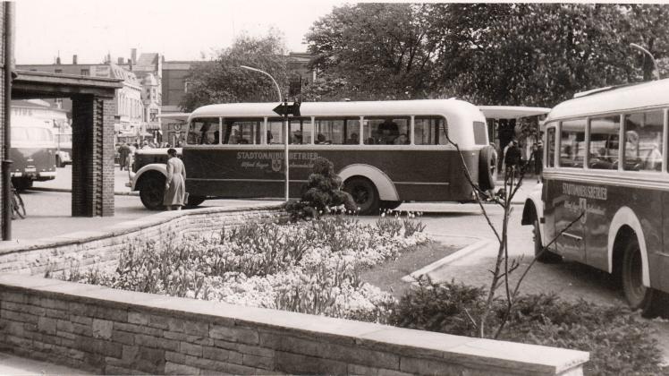 „Zweierlei Duftverbreiter“: Busse des Omnibusbetriebs von Alfred Sager halten im Mai 1957 vor der Markthalle.