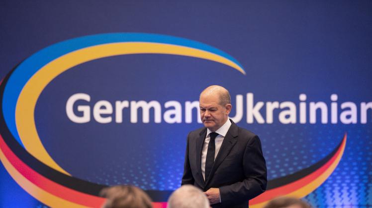 German Chancellor Olaf Scholz leaves the podium after speaking during the German-Ukraine economic forum with the motto "Rebuild Ukraine" in Berlin on October 24, 2022 to discuss the post war reconstruction of Ukraine. (Photo by Michael Kappeler / POOL / AFP)