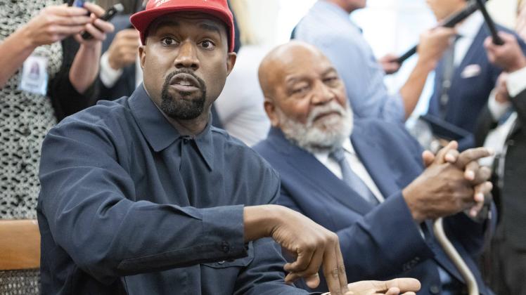 Kanye West left makes a statement to the media as he meets with United States President Donald J