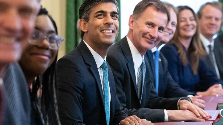 Britain&apos;s Prime Minister Rishi Sunak (C) poses for a photograph alongside Britain&apos;s Chancellor of the Exchequer Jeremy Hunt (centre right) and Britain&apos;s Secretary of State for International Trade, President of the Board of Trade and Minister for Women and Equalities Kemi Badenoch (centre left) at the first cabinet meeting under the new Prime Minister, Rishi Sunak in 10 Downing Street in central London on October 26, 2022. - Sunak&apos;s largely same-look cabinet holds an inaugural meeting today before he heads to the House of Commons for his first weekly "Prime Minister&apos;s Questions", when he will battle Labour leader Keir Starmer and other opposition lawmakers. (Photo by Stefan Rousseau / POOL / AFP)