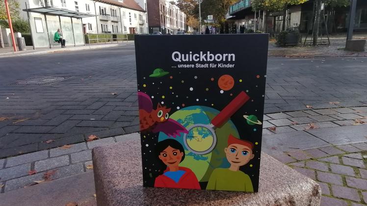 Das Kinder-Bilderbuch über Quickborn steht auf einem Stein-Poller in der Bahnhofstraße.