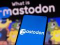 April 21, 2022, Brazil. In this photo illustration, a woman holds a smartphone with the Mastodon logo displayed on the s