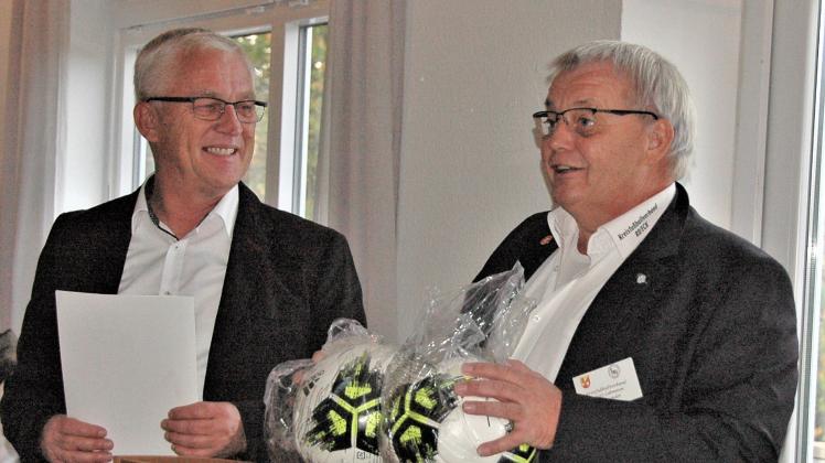 Der  Vorsitzende des KFV Rendsburg-Eckernförde, Robert Lohmann (rechts) gehörte zu einer langen Liste Gratulanten, die dem TSV Rieseby und ihrem Vorsitzenden, Gerhard Muhl, gratulierten.