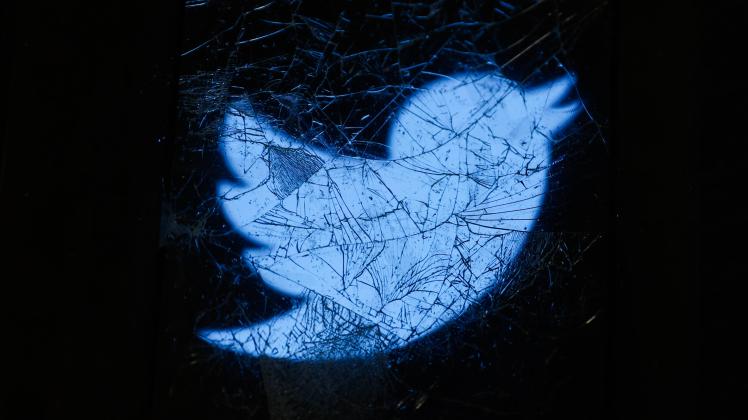 Twitter Alternatives Photo Illustrations Twitter logo displayed on a phone screen is seen through the broken glass in th