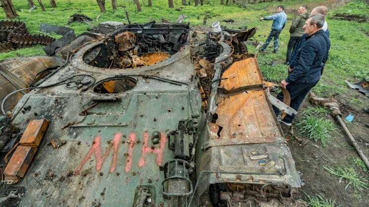 November 12, 2022, Myroliubivka, Kherson, Ukraine: A destroyed tank with a graffiti saying Mines near Myroliubivka vill