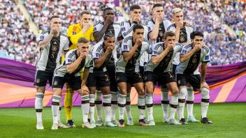 221123 The starting eleven of Germany hold their hands over their mouths in a protest as they pose for a photo ahead of