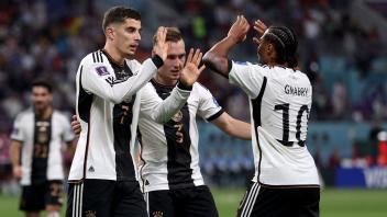 Germany&apos;s midfielder #07 Kai Havertz (L) celebrates with teammates after scoring a goal, which was later disallowed after a VAR review, during the Qatar 2022 World Cup Group E football match between Germany and Japan at the Khalifa International Stadium in Doha on November 23, 2022. (Photo by ADRIAN DENNIS / AFP)