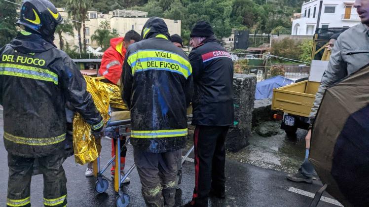 (221127) -- ROME, Nov. 27, 2022 -- Emergency staff members transfer an injured person after a landslide on the island of