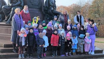 Fotostopp im Schlossgarten: Am Denkmal für Großherzog Friedrich Franz II. postieren sich die Kinder auf den Stufen des Sockels.