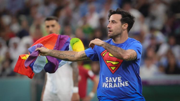 A streaker with a tee-shirt of superman saying save Ukraine, runs on the field during a soccer game between Portugal and