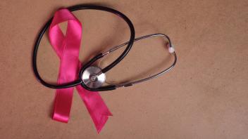 Closeup of a pink ribbon and stethoscope on wood background, concept of the month to fight breast cancer , 22802204.jpg,