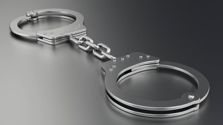 Handcuffs standing on gray background. 3D illustration Handcuffs standing on gray background. 3D illustration. Copyright