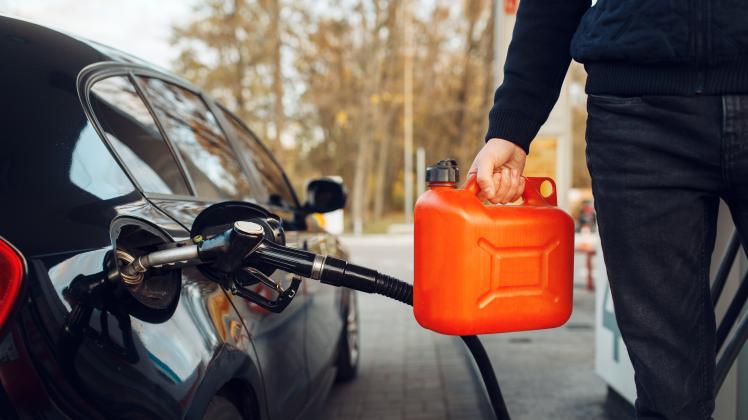 Man holding canister on gas station, fuel filling, Man holding a canister on gas station, fuel filling. Petrol fueling, 