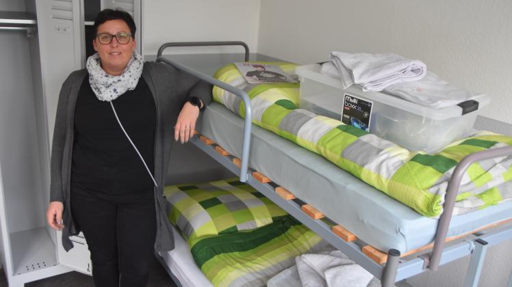 Sachbearbeiterin Diana Rechlin vor einem der Betten in der Sylter Obdachlosenunterkunft. 