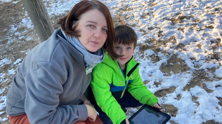 Liam Hellenberg (6) zeigt Erzieherin Katja Olthoff das Foto mit den Vogelspuren im Schnee, das er mit dem Tablet im Garten der Kita gemacht hat.