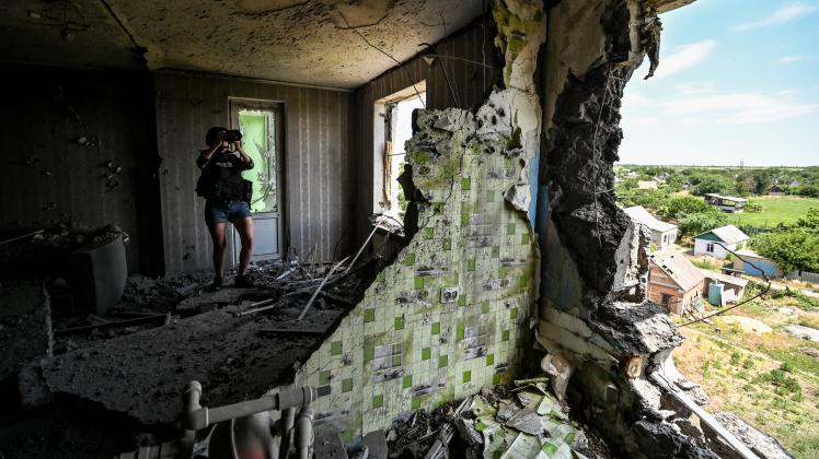 ZAPORIZHZHIA REGION, UKRAINE - JUNE 10, 2022 - A journalist takes pictures of the consequences of russian shelling of h