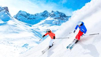 Man and woman skiing downhill on snowcapped mountain in Lech, Austria model released, VTF00656