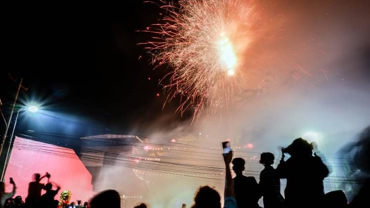 Indonesian Marks Lunar New Year Celebration Indonesians people witness the fireworks that shine above of the temple as a