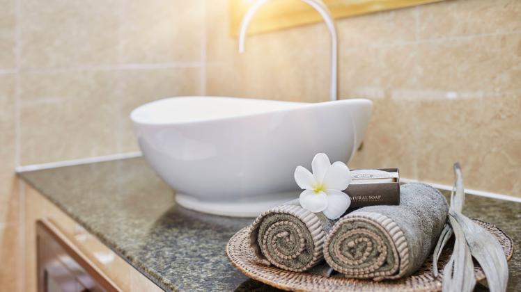 Fresh rolled towels and soap bars with frangipani flower in bathroom property released, RORF02959