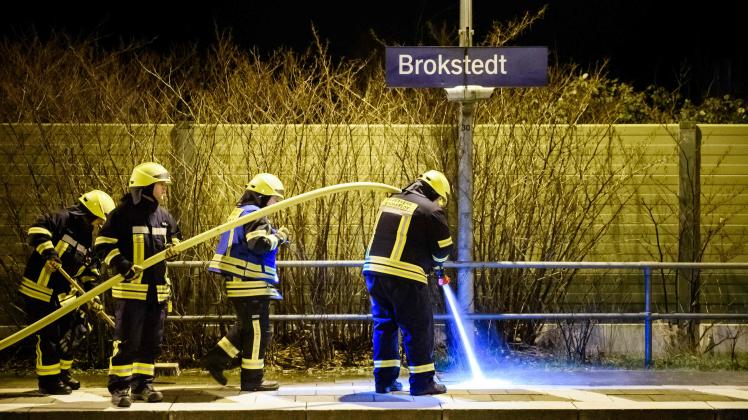 TOPSHOT - Firefighters of a local fire department clean the platform at the train station in Brokstedt, northern Germany, after two people were killed and several others wounded in a knife attack on a regional train between the cities of Hamburg and Kiel. - Police announced that the alleged assailant had been captured. The suspect was taken into custody at the railway station in the town of Brokstedt. It was not immediately clear how many people had been injured or how serious their condition was. Media reports cited around five wounded. (Photo by Gregor Fischer / AFP)