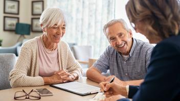 Senior couple consulting with financial agent
