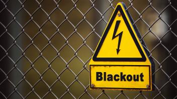 Bavaria, Germany - 28 November 2022: sign on a fence with the inscription: Blackout. Energy crisis PHOTOMONTAGE *** Schi