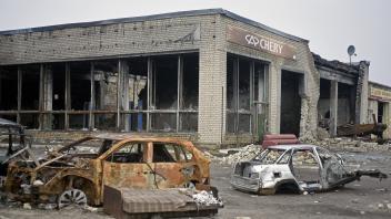 Izium after Russian occupation IZIUM, UKRAINE - DECEMBER 25, 2022 - Burnt-out cars are seen outside a car dealership des