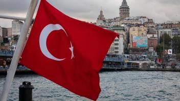 October 17, 2022: Turkish Flag with background of Galata Tower located in Beyoglu district of Istanbul, Turkiye on Octob