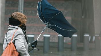 Third Storm Antonia Hits In Cologne a woman struggles with her umbrella against the strom wind in front of Cologne Dom C