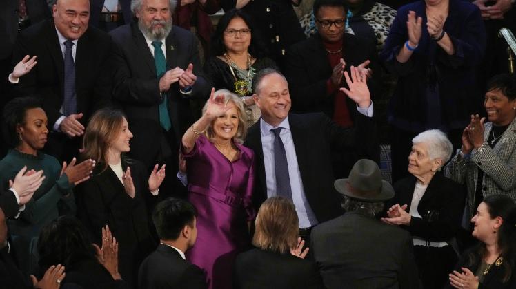 First Lady Jill Biden and Second Gentleman Doug Emhoff wave before President Joe Biden s State of the Union address to a