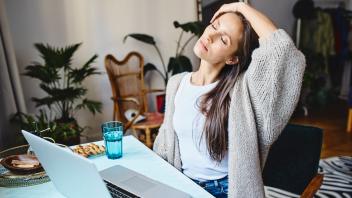 Tired freelancer with eyes closed sitting at desk model released, Symbolfoto property released, BSZF02012
