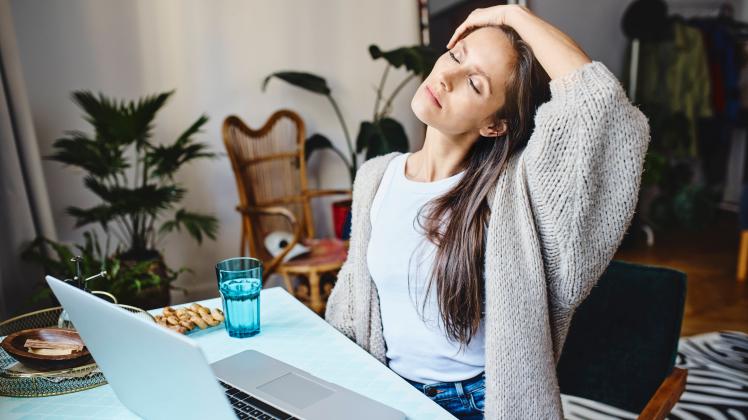 Tired freelancer with eyes closed sitting at desk model released, Symbolfoto property released, BSZF02012