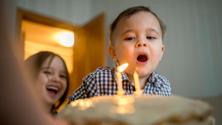 Boy blowing candles on cake and celebrating his birthday at home model released, Symbolfoto property released, ANAF00844