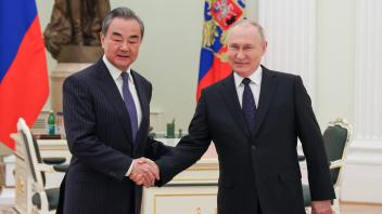 RUSSIA, MOSCOW - FEBRUARY 22, 2023: Russia s President Vladimir Putin (R) and Chinese State Councillor Wang Yi, director